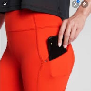 Red Athleta leggings with zipper pockets. XXS